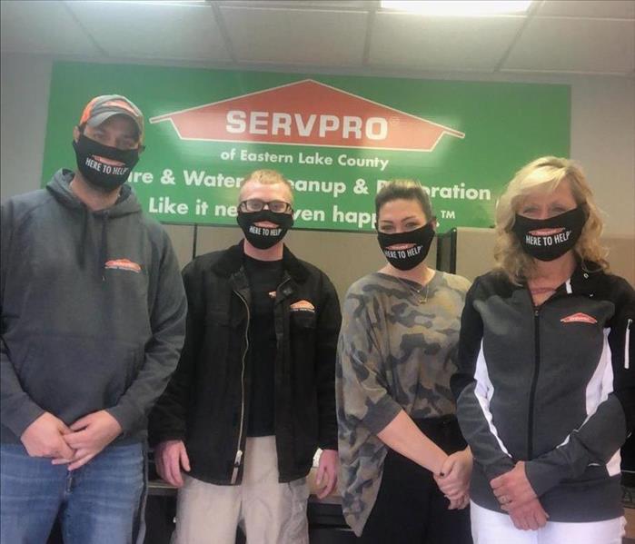 employees with Here To Help face masks on